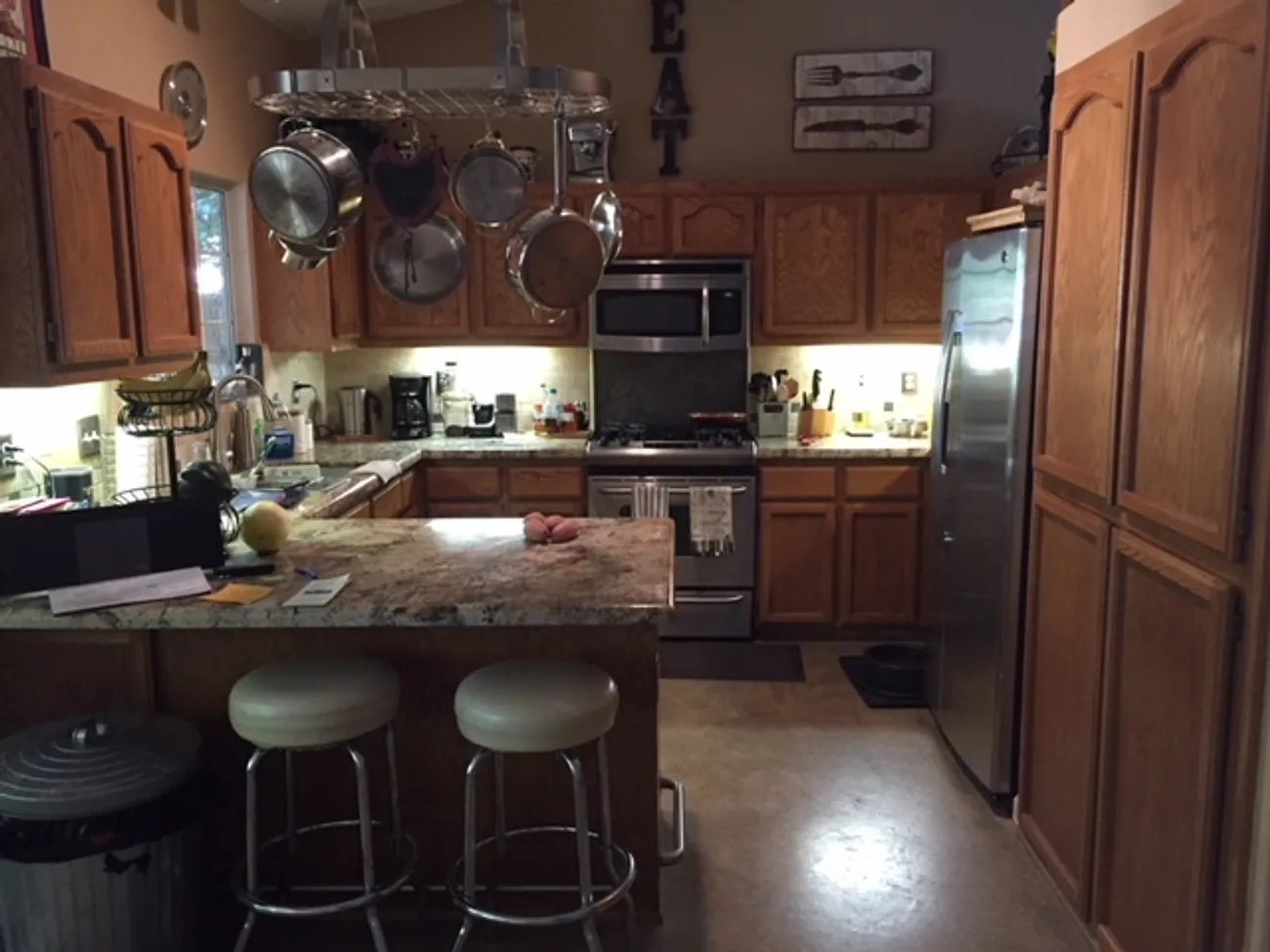 Kitchen with honey oak cabinets, before painting