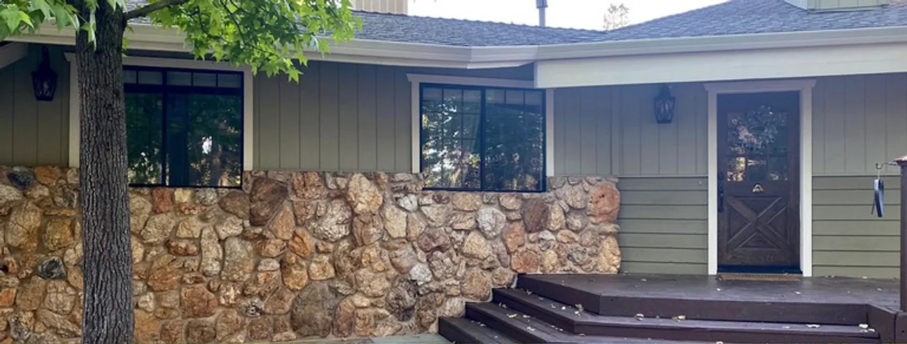 Home exterior in sage green siding, before repainting
