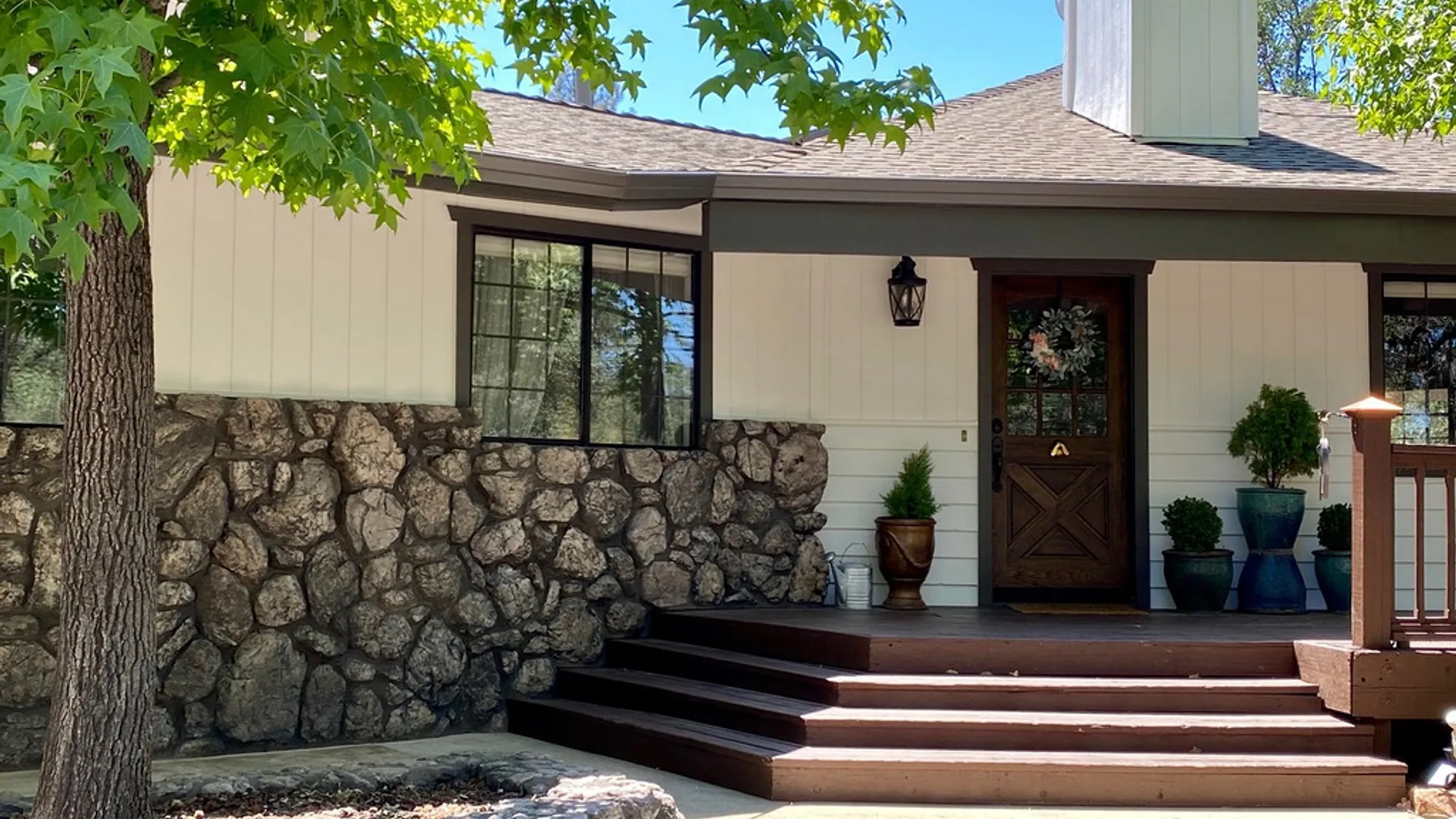 A Redding-area home exterior repainted by Talbot Painting in warm cream with dark brown trim