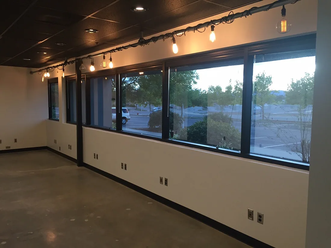 Commercial office interior with a full window wall, painted walls and ceiling