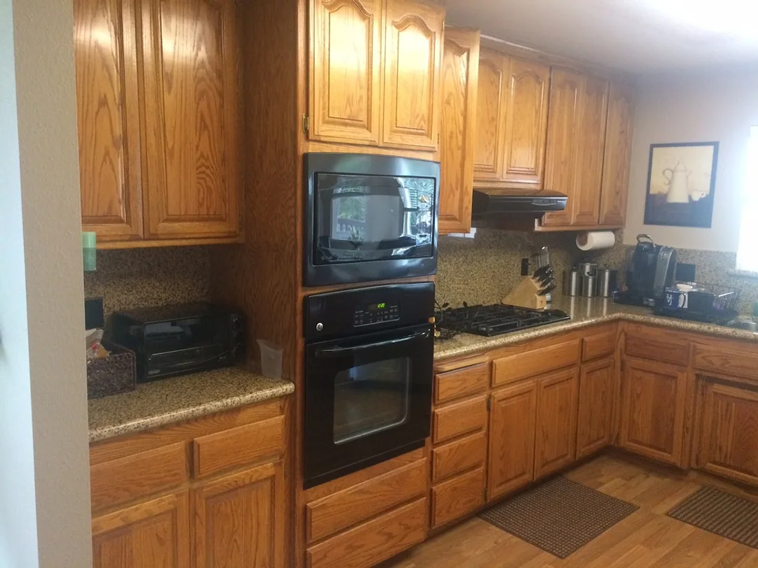 Kitchen with honey oak cabinets before painting