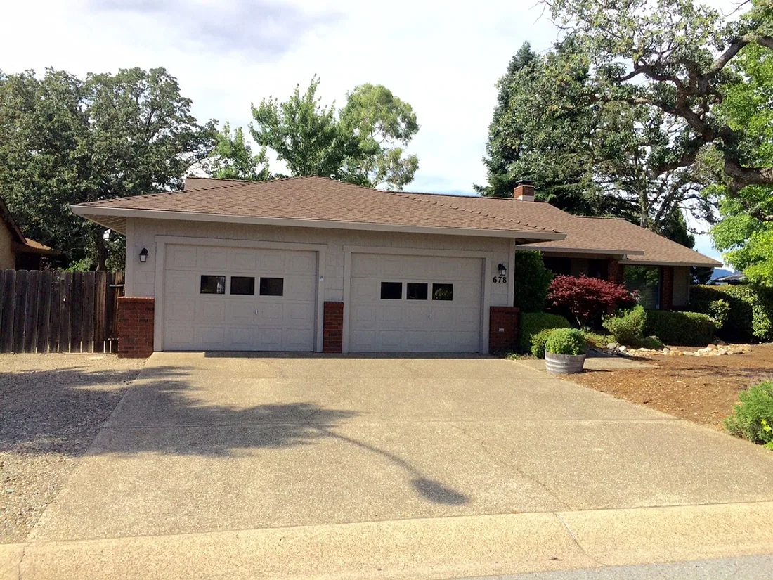 Ranch home exterior and attached garage after painting
