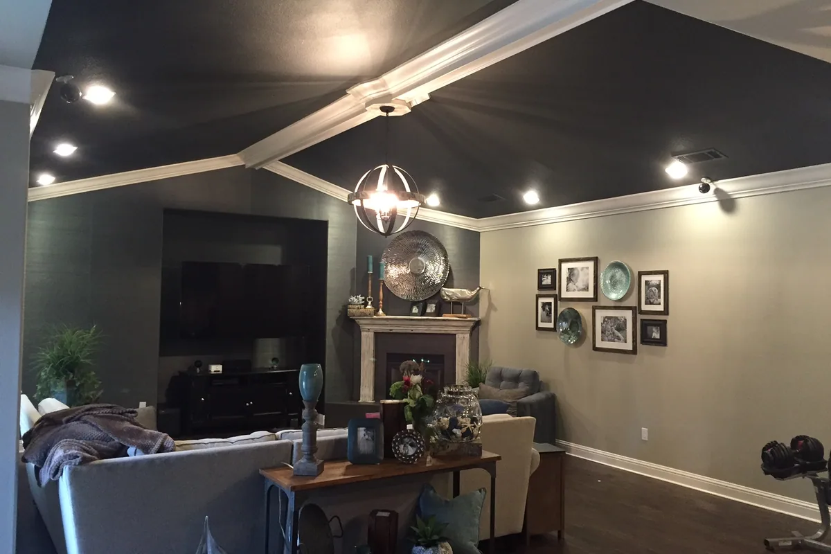 Living room painted by Talbot Painting, with a dark feature ceiling, painted walls and white trim